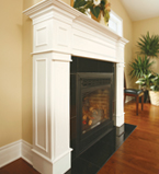 Fireplace with white moulding along the edges with matching white baseboards along the wall