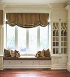 Large window bench with white moulding along the outside
