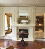 Living room with white moulding around the fireplace