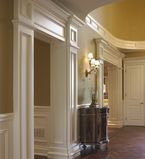 Foyer With white moulding along the entrance to other rooms